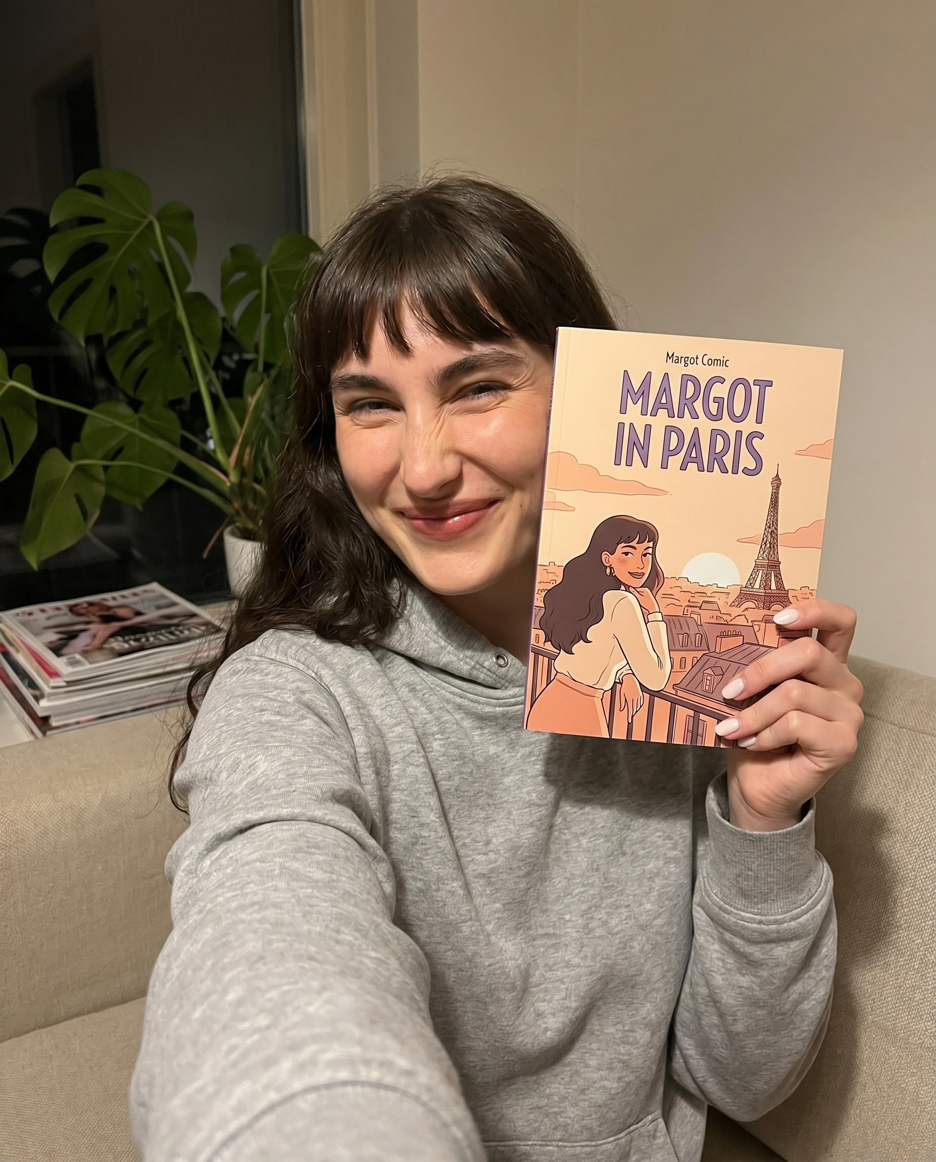 Margot L. holding their printed comic