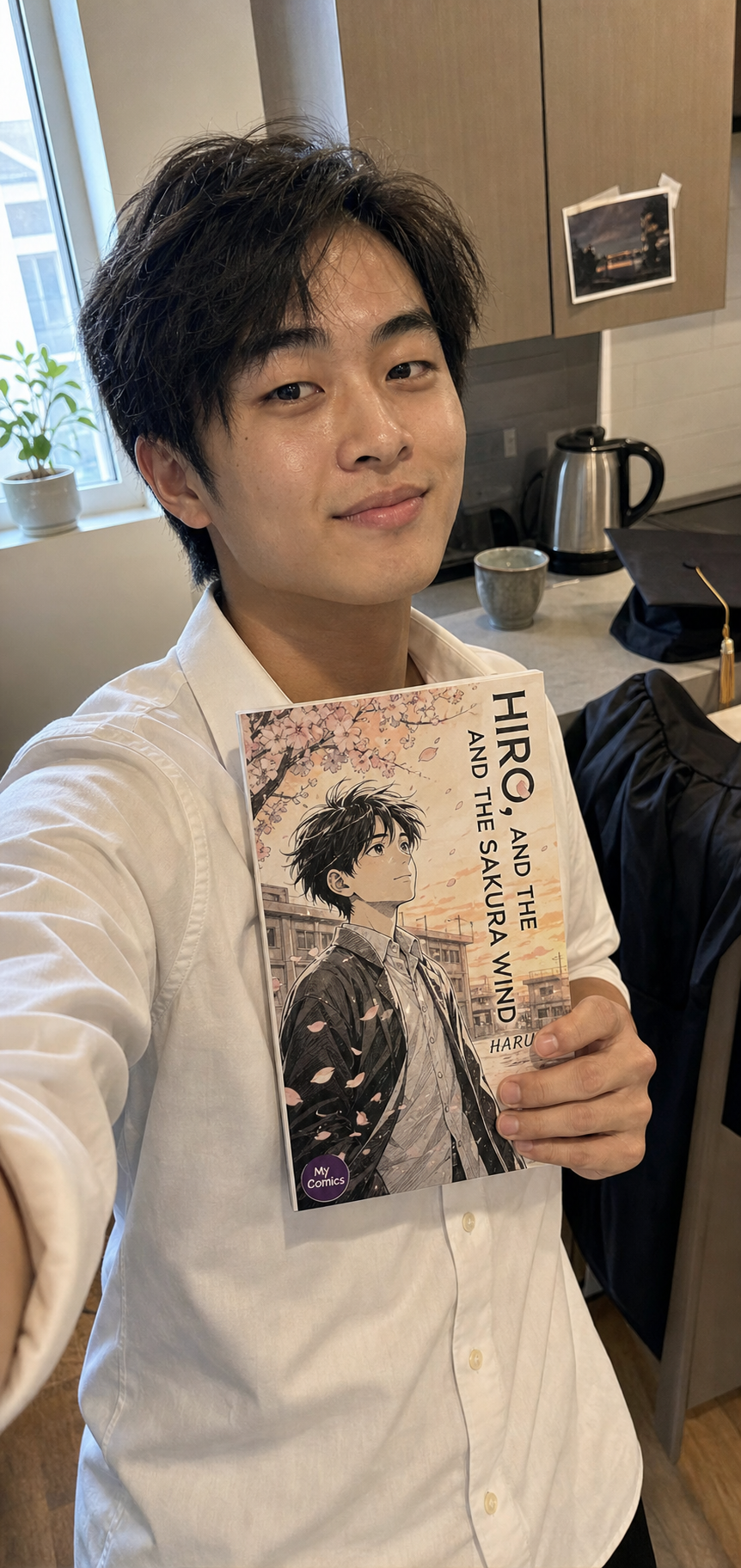 Hiro K. with their printed graduation comic